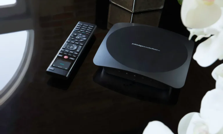 Control4 controller and remote on a dark table