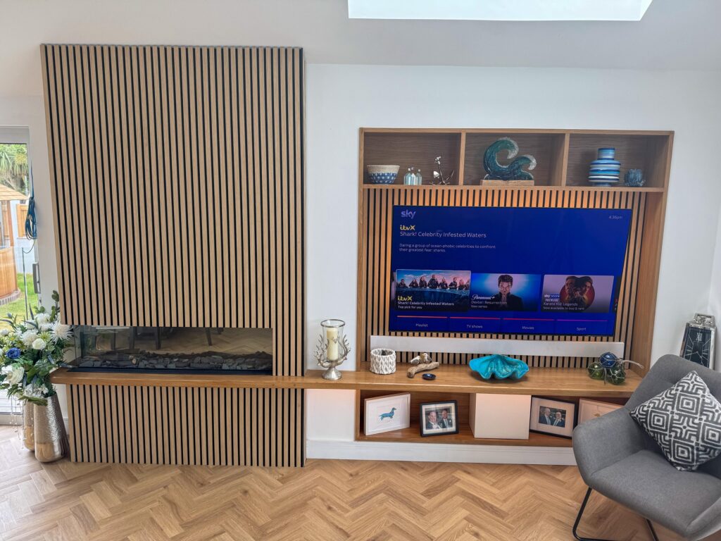 Living room media wall with slatted panelling and a wall-mounted TV