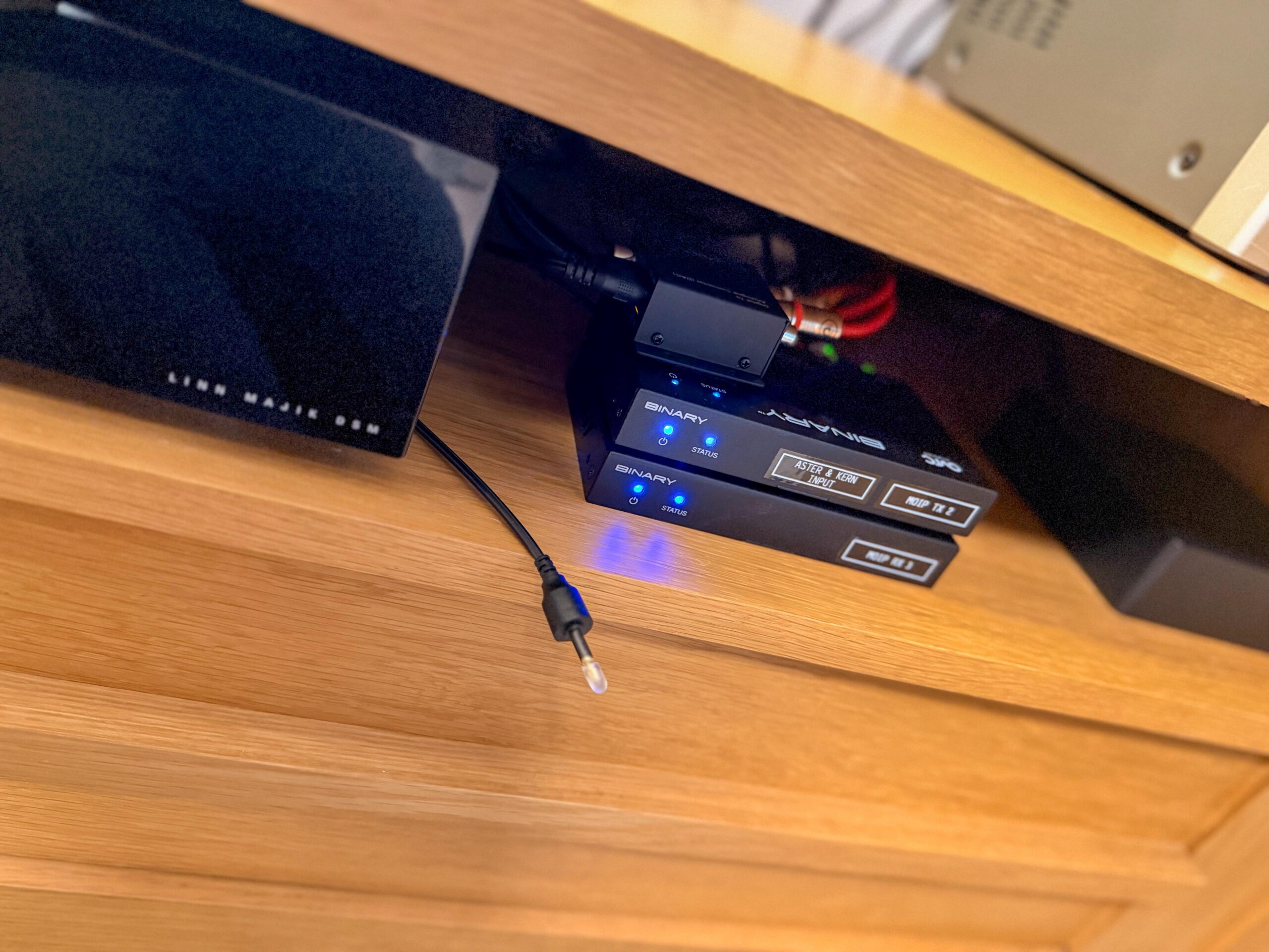 AV equipment mounted beneath a wooden shelf